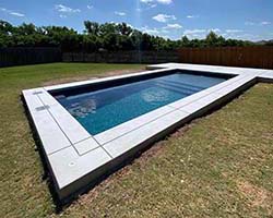 Gunite inground pool design build Oak Island, Texas. Near Longview swimming pools contracting companies special discount prices on concrete.